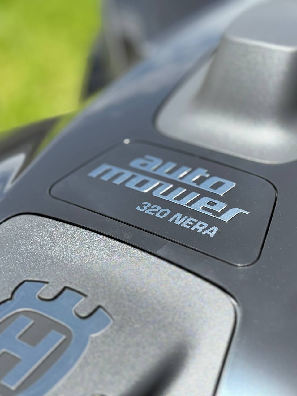Close-up of a Husqvarna auto mower 320 NERA label on a lawn mower