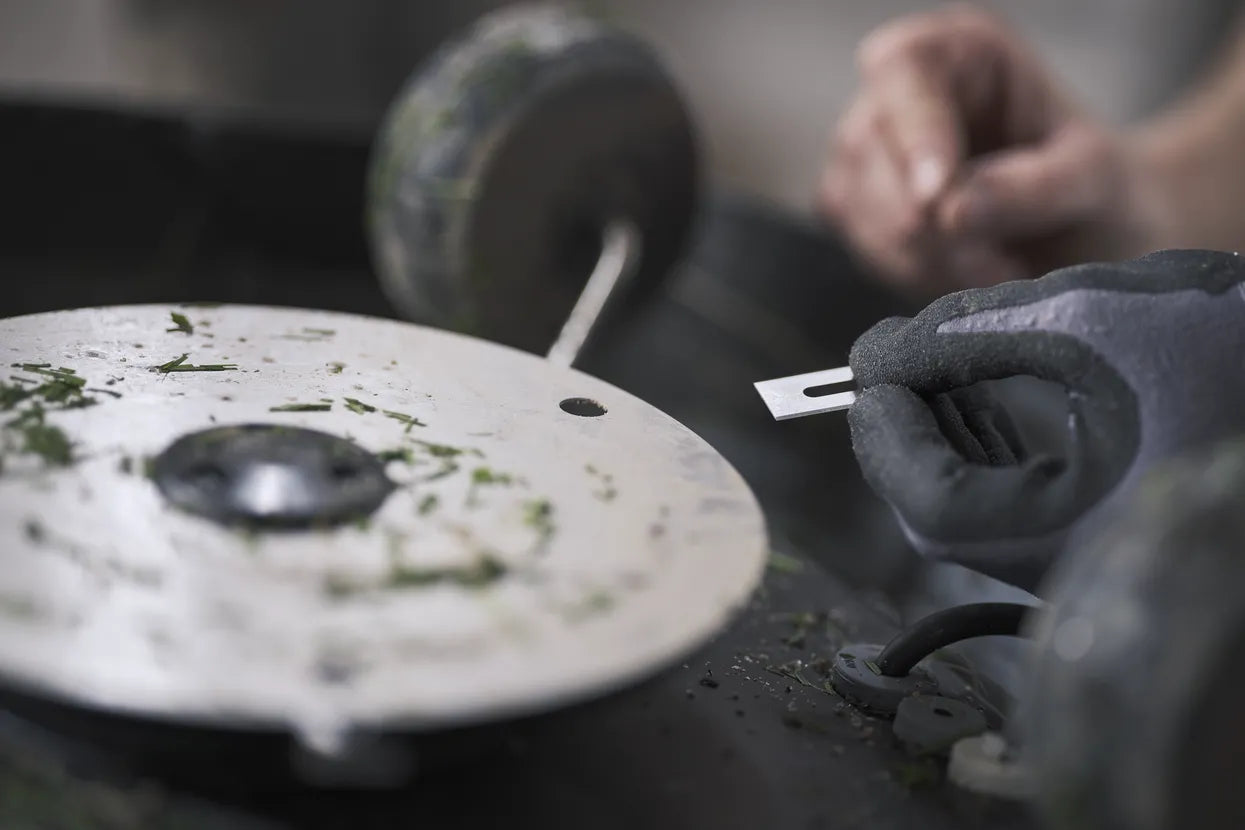 Close-up of a person replacing Automower Blades