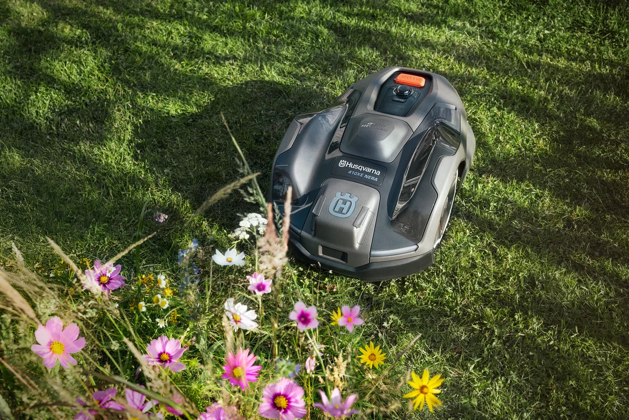 Husqvarna Automower 410XE NERA Robotic Lawn Mower 970654406 Near Flowerbed