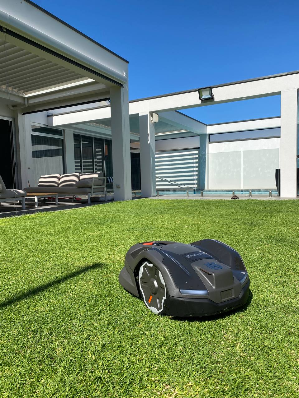 Husqvarna Automower 410XE on a well-maintained lawn in front of a modern house in Medindie-South Australia