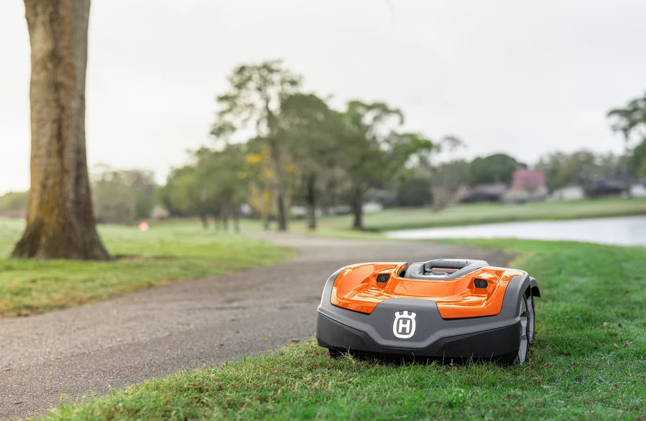 Husqvarna Commercial Automower 535X AWD robotic lawn mower mowing near the path