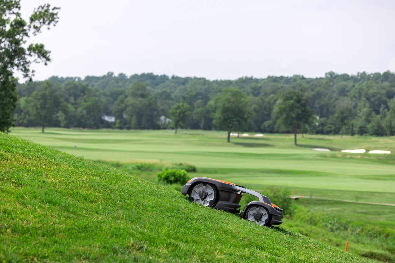 Husqvarna Commercial Automower 535X AWD robotic lawn mower mowing the lawn on a scenic background