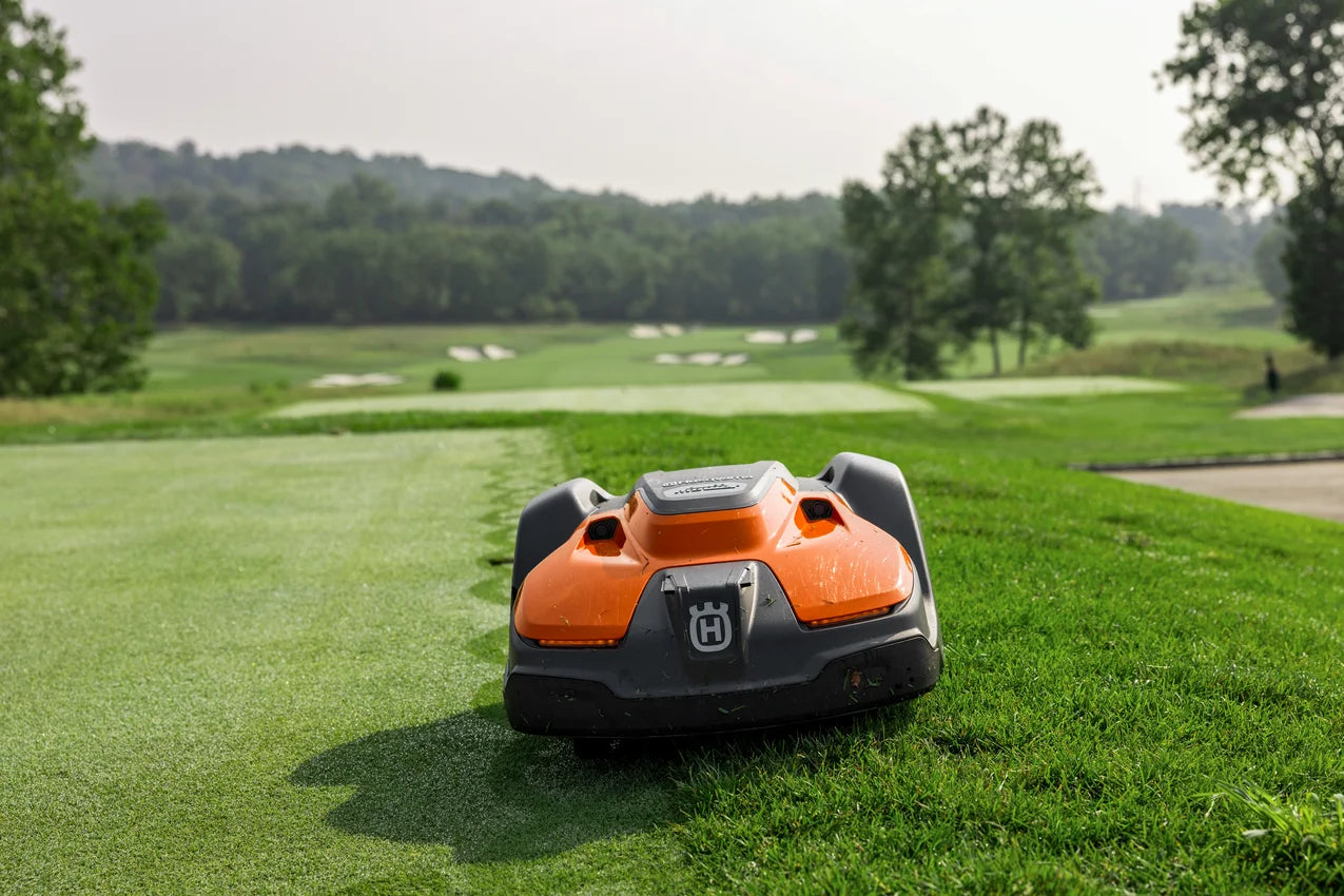Automower 550 EPOS Commercial Robotic lawn mower on a golf course with trees and fairways in the background