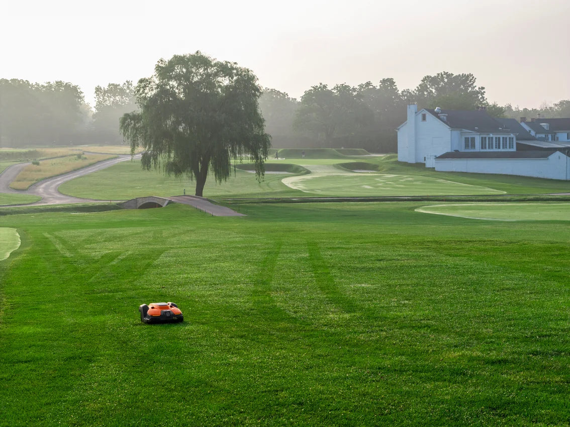 Golf course with a Automower 550 EPOS commercial robot lawn mower on a misty morning