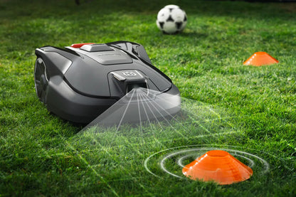 Automower 312V Husqvarna 970 83 11-06 on grass with soccer ball and orange cones in the background