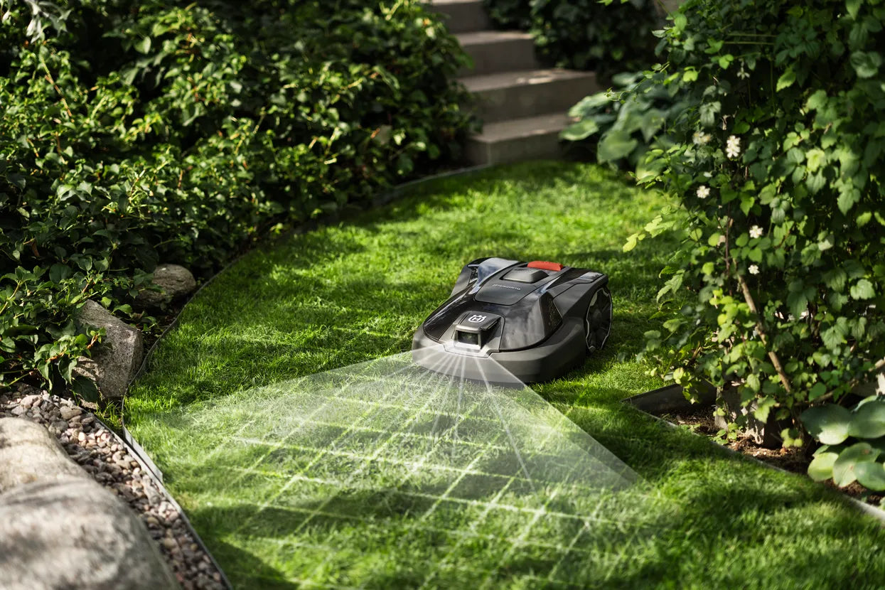 Automower 312V Husqvarna 970 83 11-06 on a grassy area with a garden setting