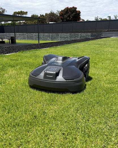 Husqvarna Automower 320 NERA on a grassy area with a fence and trees in the background in Murray Bridge-South Australia-2