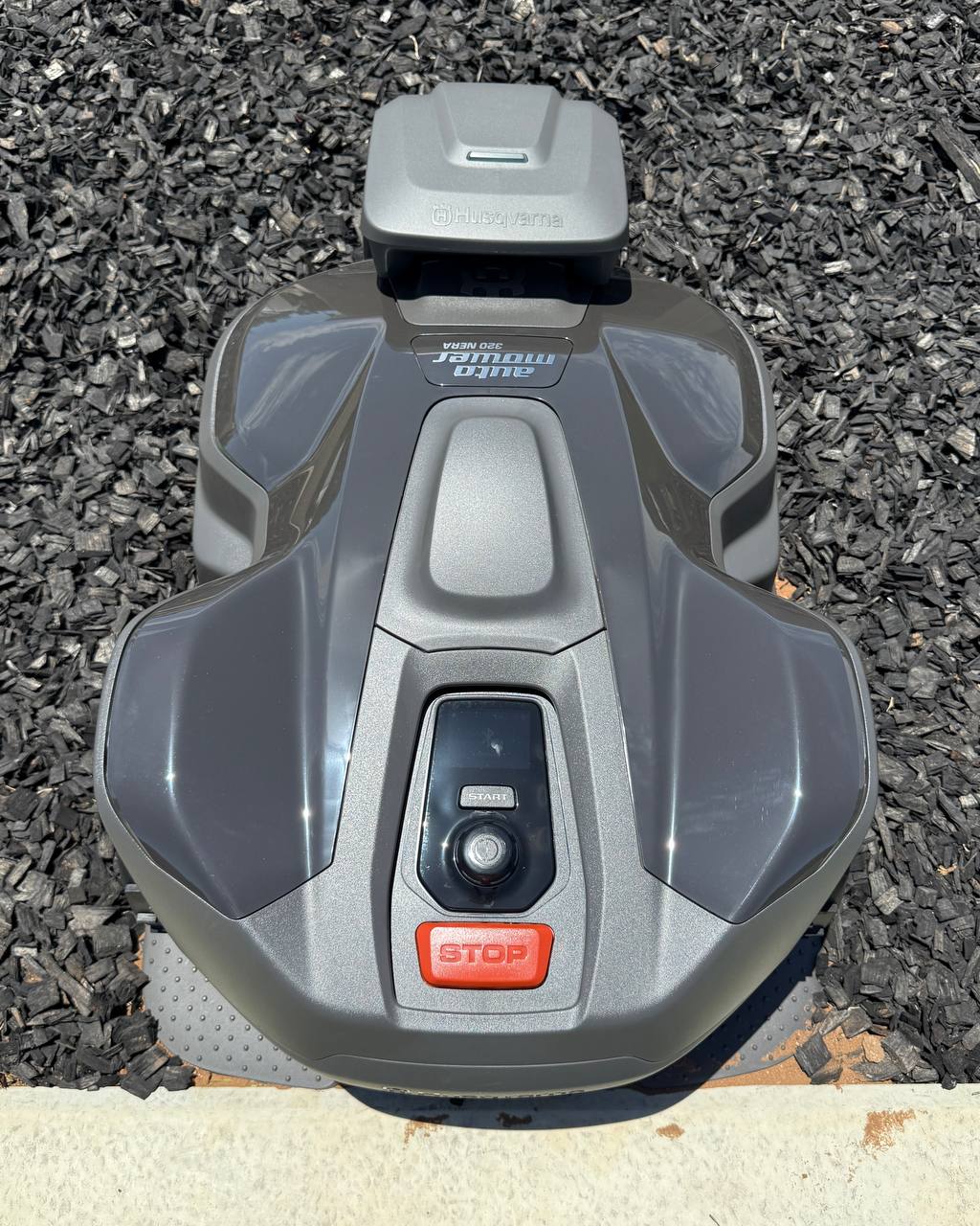 Husqvarna Automower 320 Nera in Charging Station on a black mulch in Murray Bridge-South Australia