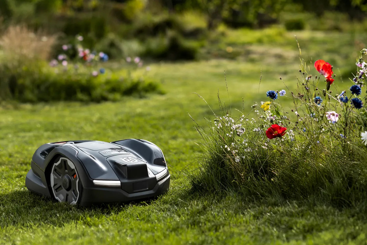 Husqvarna Automower 410XE NERA Robotic Lawn Mower 970654406 Near Flowers